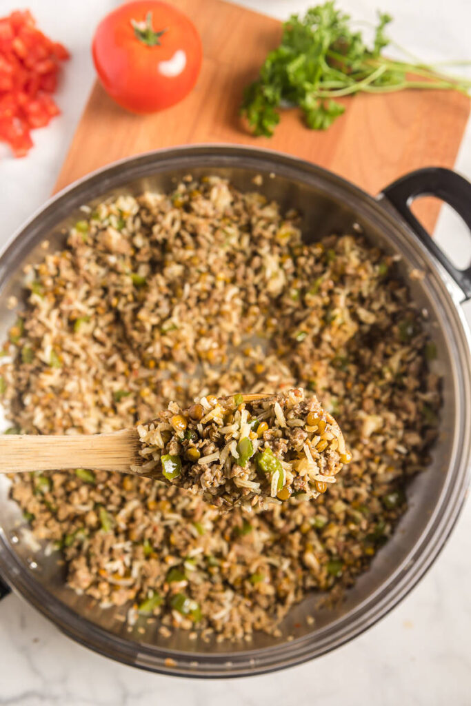 Finished Sausage Lentil and Rice Skillet dinner recipe in pan on cutting board.