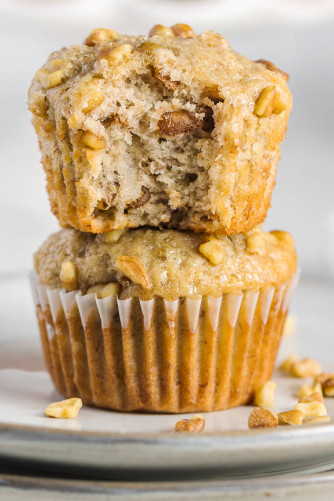 2 soft banana muffins with walnuts on a plate