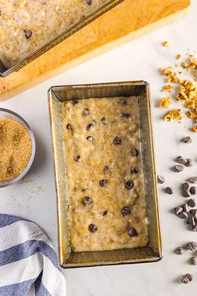 Chocolate chip walnut banana bread in a pan with sweet sugar topping