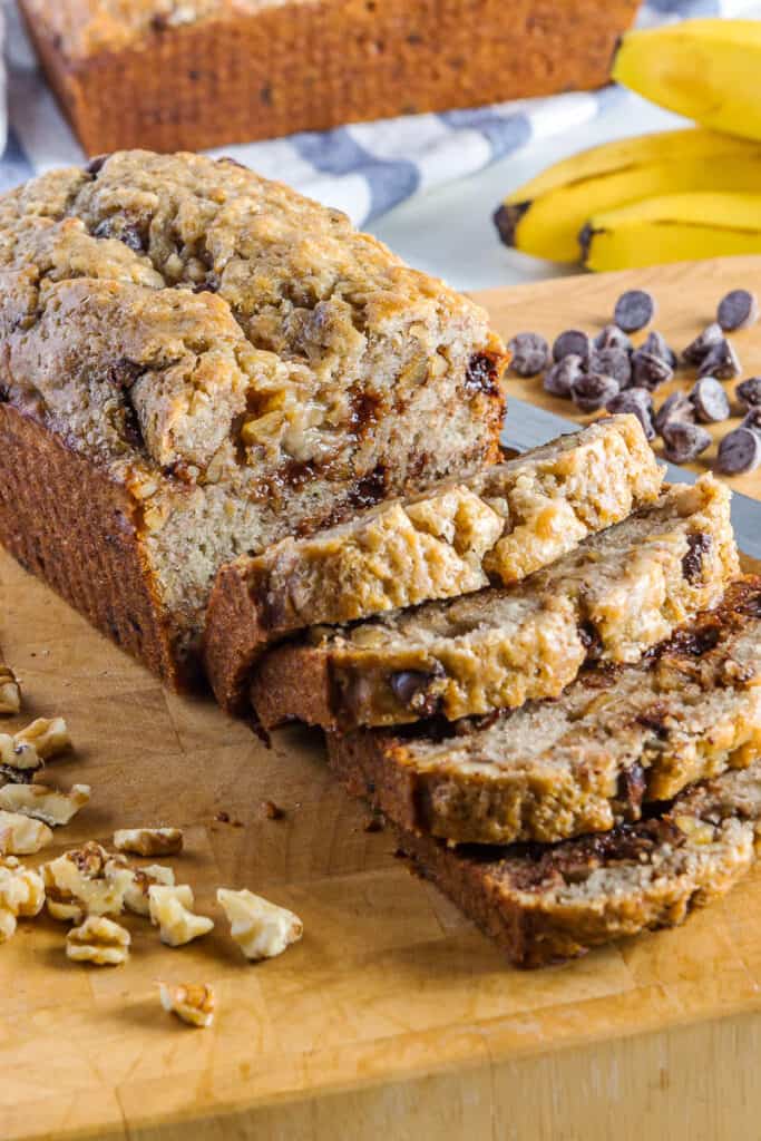 Slices of chocolate chip banana nut bread on a cutting board